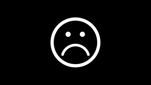 Грусный смайлик на чёрном фоне
