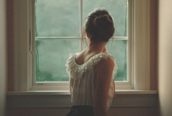 Девушка у окна со спины