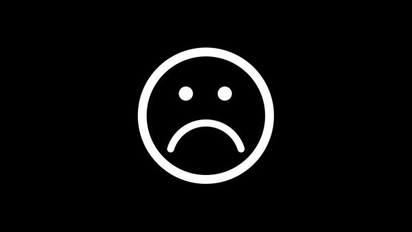 Грустный смайлик на черном фоне