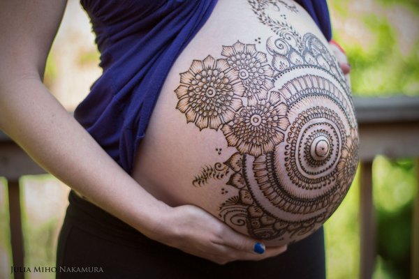 Рисунок хной на животе беременной